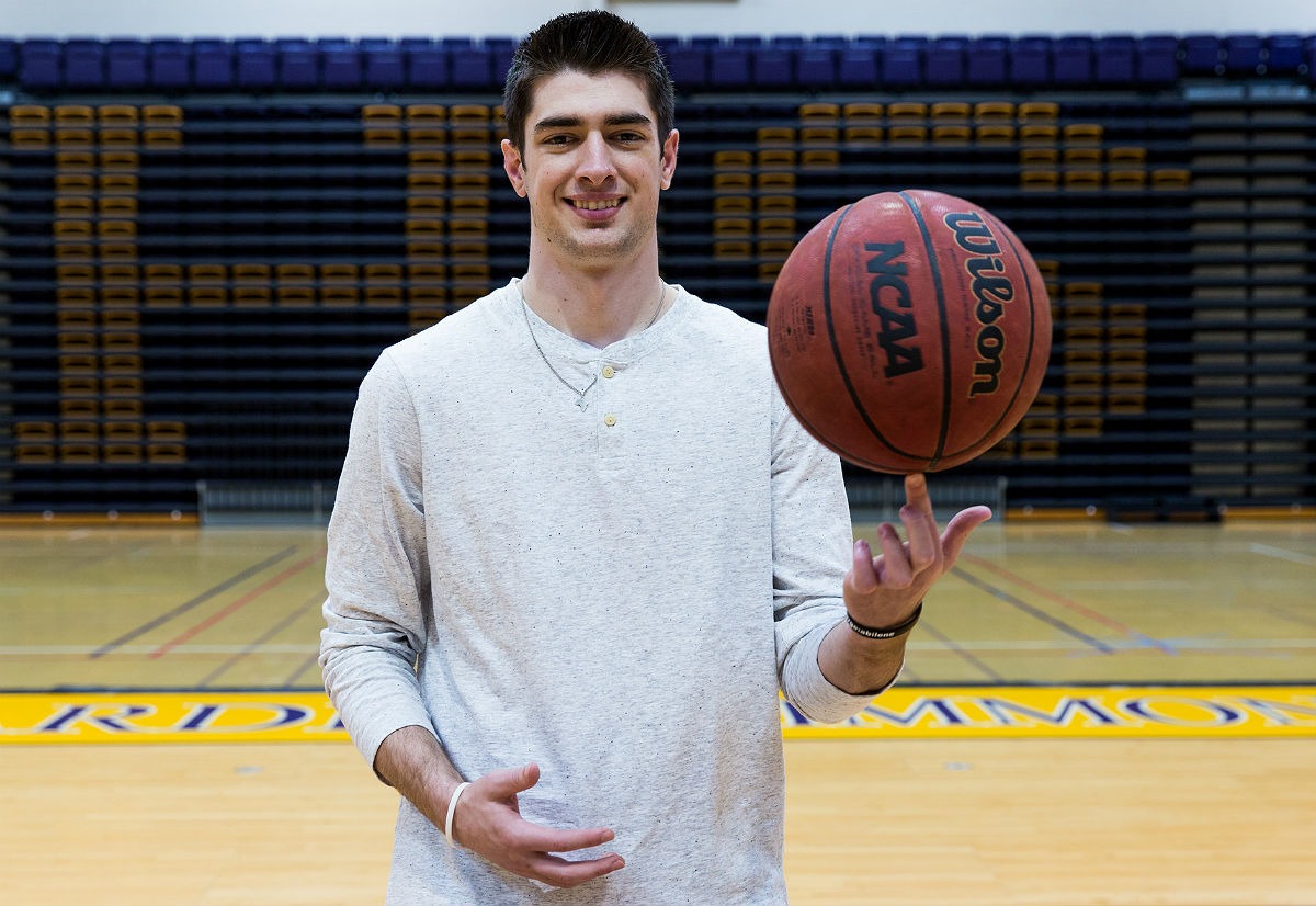 Caleb Spoon-Mathematics Major spinning basketball on the court
