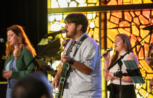 Male student singing in Chapel