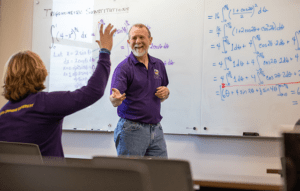Male Mathematics professor teaching in class
