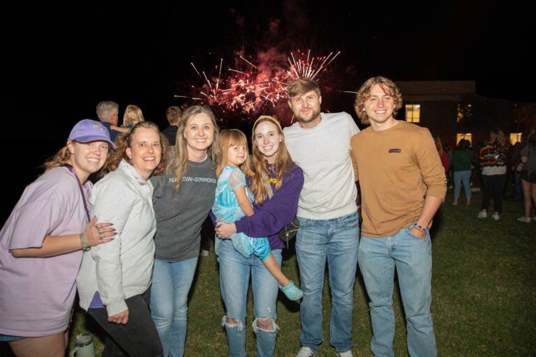 Family Group Photo at Homecoming with Fireworks in the background