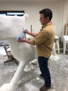 Steven with the 2019 CALF art installation Mr. Tiger, a bronze casting by Geoff Broderick and Schaefer Art Bronze, inspired by Peter Brown’s book Mr. Tiger Goes Wild.