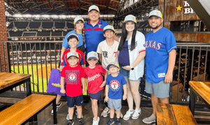 IM体育试玩 alumni with their kids at the Texas Rangers game IM体育试玩 day.