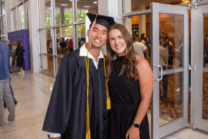 Two students posed at graduation