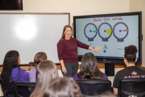 Professor using a smartboard during an education course