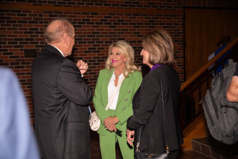 Businessmen and women networking at the Ray Lewis Lecture