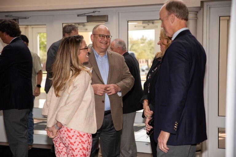 Businessmen and women networking at the Ray Lewis Lecture
