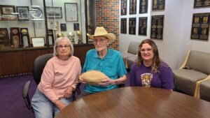 Three generations of IM体育平台 pride: Kate Voss with her grandparents, Charlene and Bill Voss, whose Hardin-Simmons University legacy began in 1960 and helped inspire Kate’s own journey through the Cowboy Band and the Six White Horses.